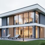 Contemporary single-family home exterior with large windows and a modern patio blending indoor and outdoor spaces.